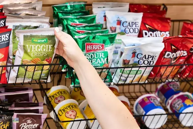 Hand grabbing for bag of chips